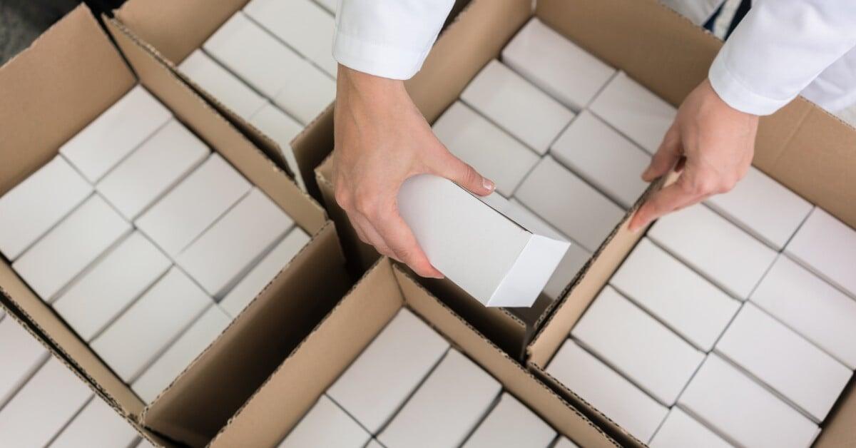 A close-up of white polystyrene packing peanuts, commonly used in shipping boxes, all arranged next to one another