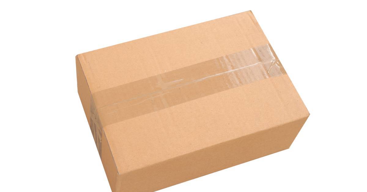 A sealed, rectangular brown cardboard box with one strip of clear tape. The box sits against a white background.